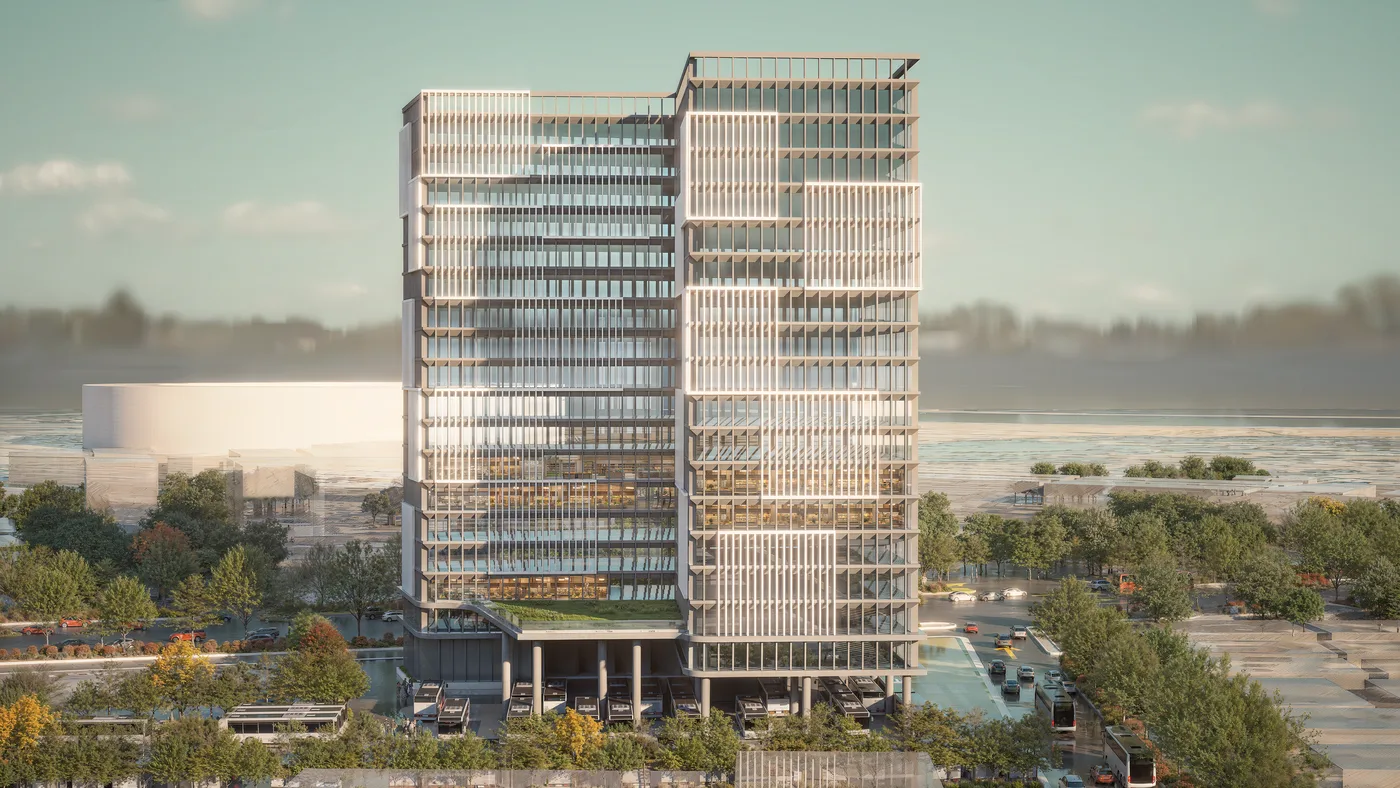 Tall tiered tower over a bus and transit depot at golden hour